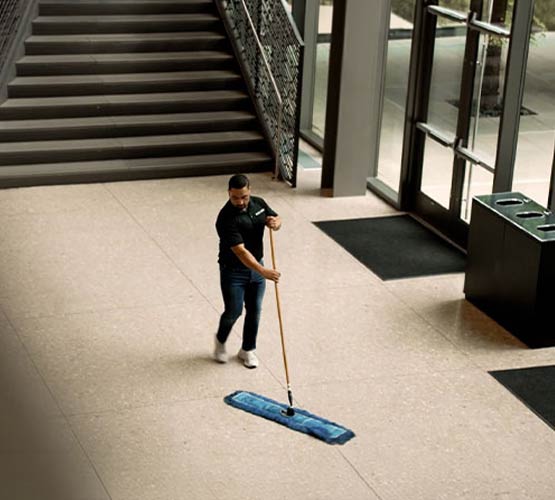 A man cleaning floor in commercial space
