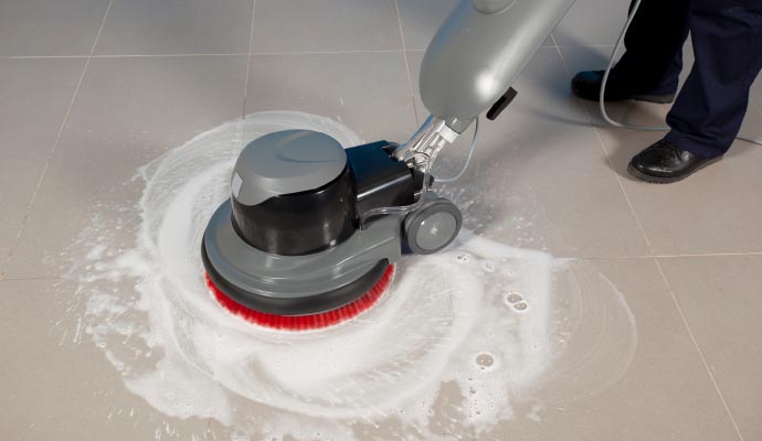 Floor buffer machine scrubbing and cleaning commercial tile and grout