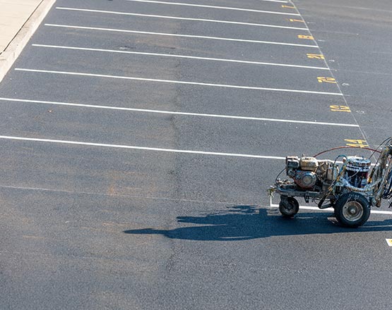 Drawing white lines with a parking lot striping machine