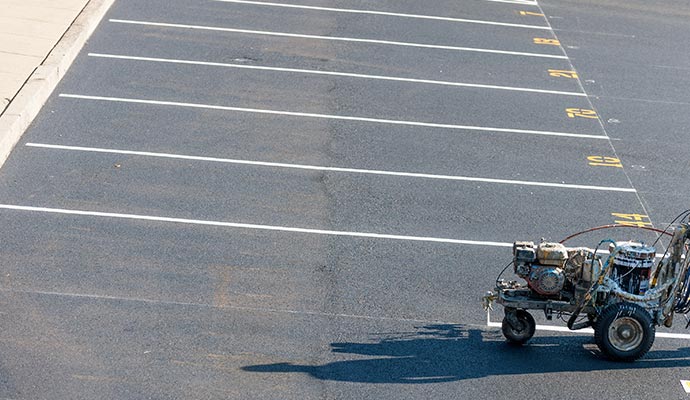 Drawing white lines with a parking lot striping machine