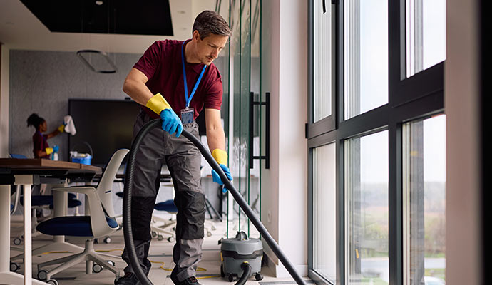 Expert cleaning office space with machine