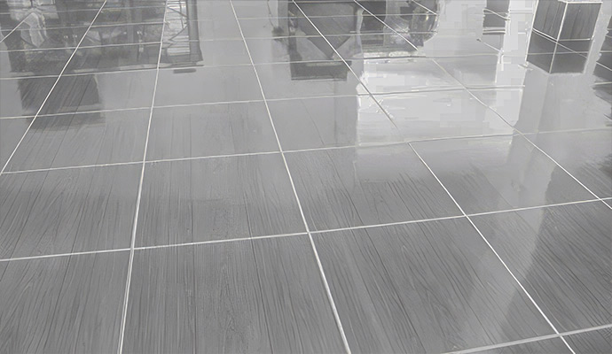 Clean polished ceramic tile floor with pristine white grout lines