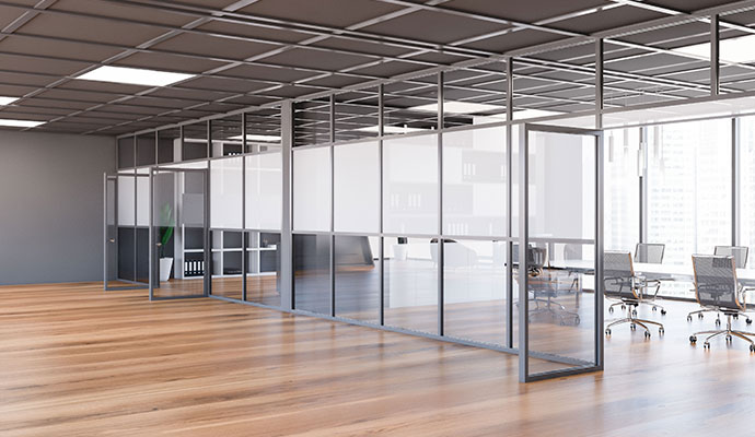 Modern office interior featuring clean wooden floor and workstations