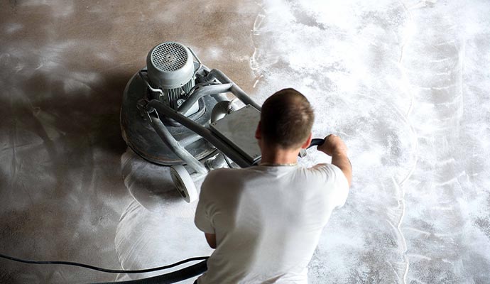 Professional using advanced floor polishing equipment to clean and polish a commercial floor