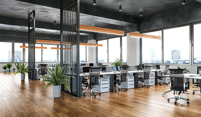 Polished hardwood floors in a modern open-plan office with desks and workstations