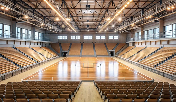 Indoor arena event venue with court seating and overhead lighting