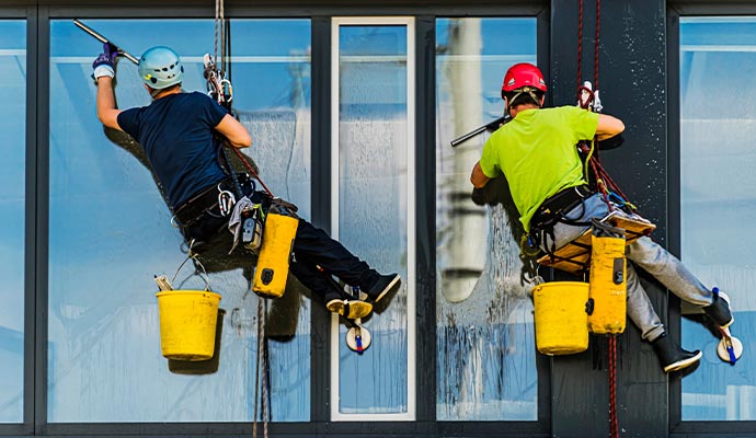 Couple of cleaner cleaning window