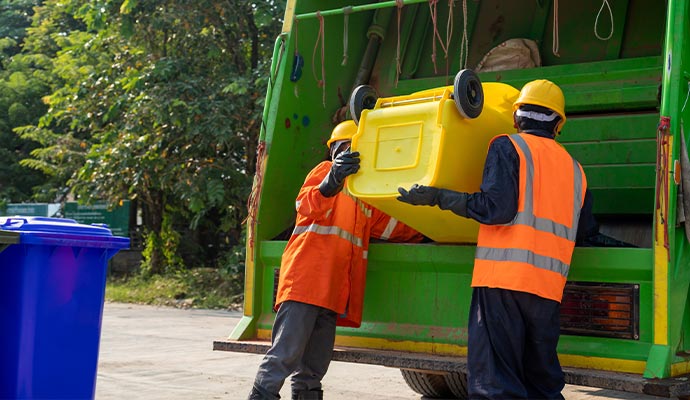 Couple of workers collecting garbage