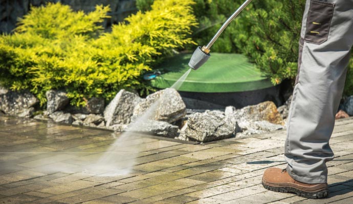 Professional pressure washing of concrete surface for thorough cleaning