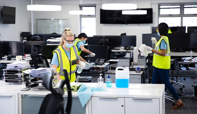 Professional cleaning team thoroughly cleaning office space