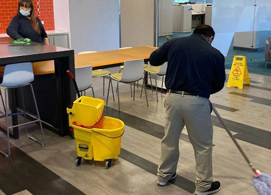 Professional team cleaning floor in order to maintain a clean and well-kept commercial property