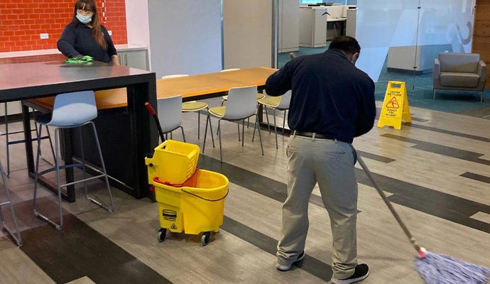 Professional team cleaning floor